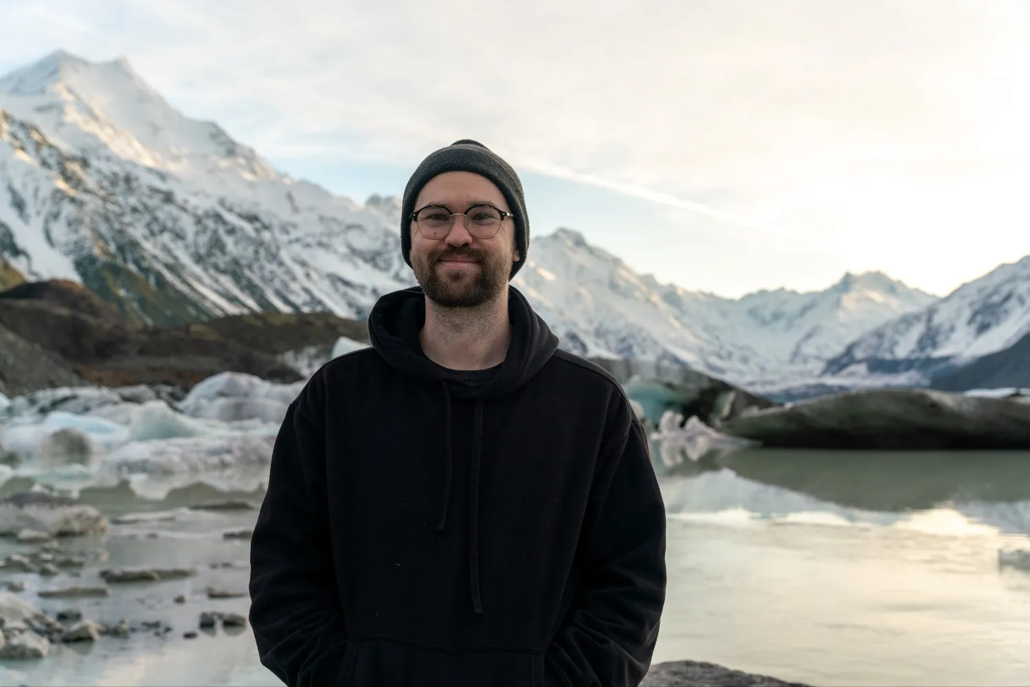 Mitchell Henderson in front of a glacier and mountains