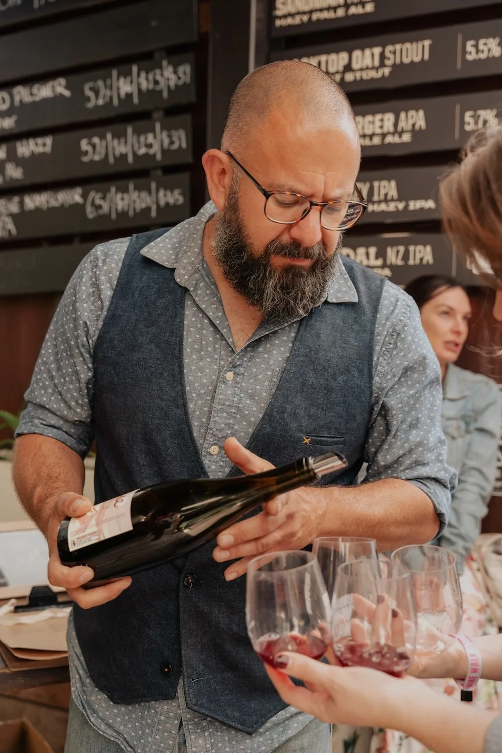 Sommelier pouring wine at a tasting