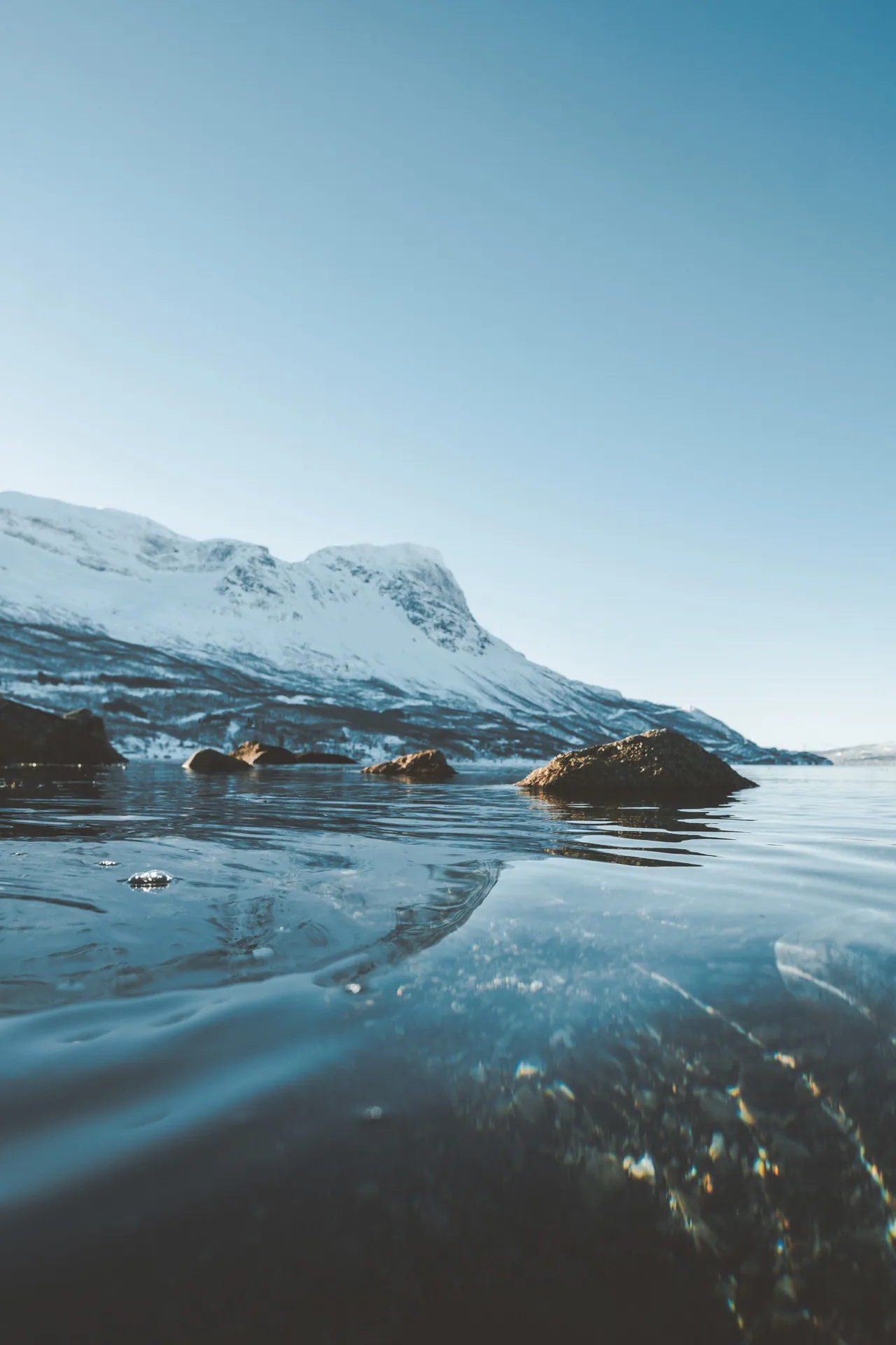 Snowy mountains reflected in a still alpine lake