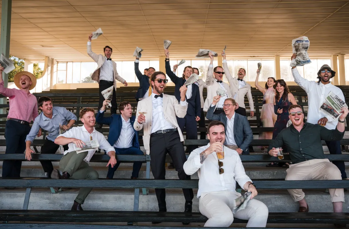 Wedding guests cheering in the grandstand